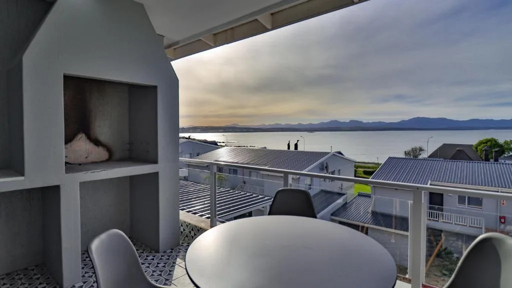 Panoramic ocean and mountain vista from modern apartment deck overlooking Mossel Bay
