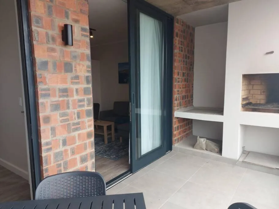 Modern outdoor patio with sliding glass doors and built-in storage shelving