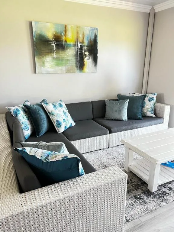Modern lounge with grey upholstered seating and decorative blue patterned cushions