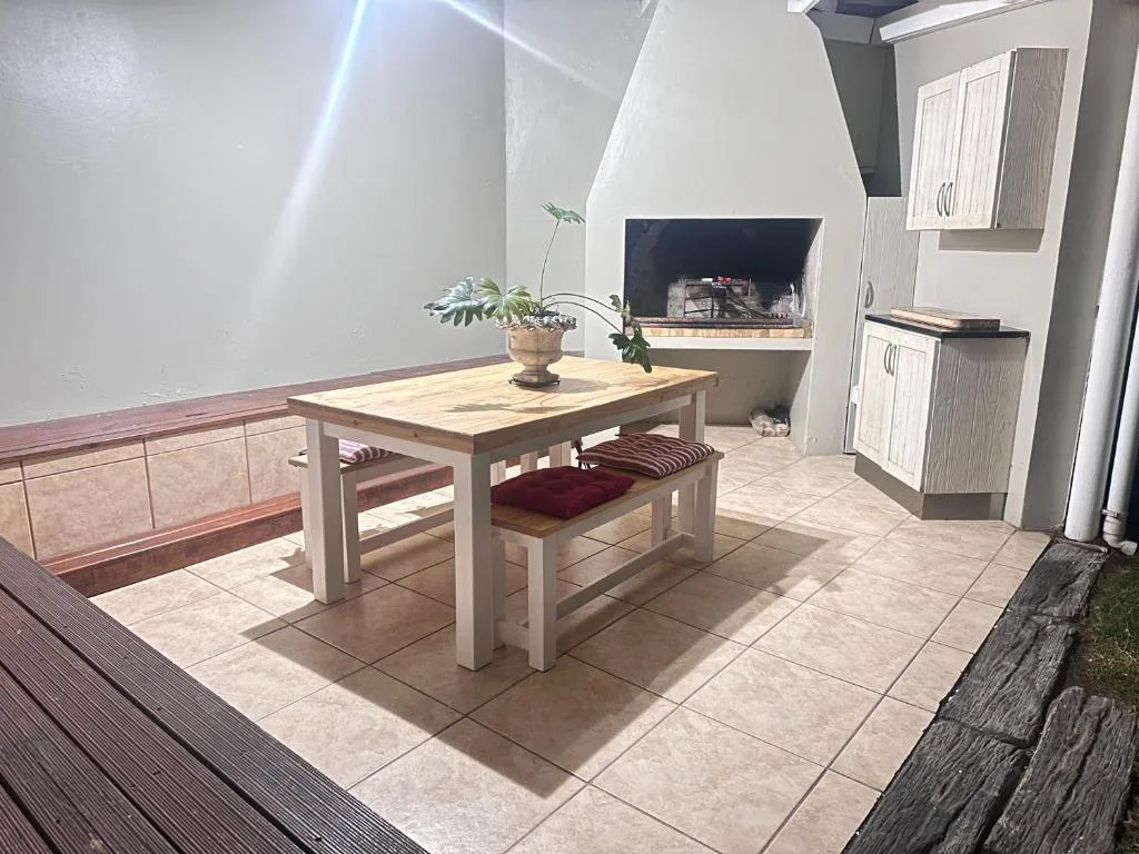 Open-plan living space with dining table, fireplace, and modern furnishings