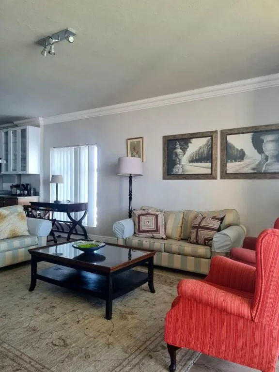 Bright living room with comfortable seating, coffee table, and framed artwork