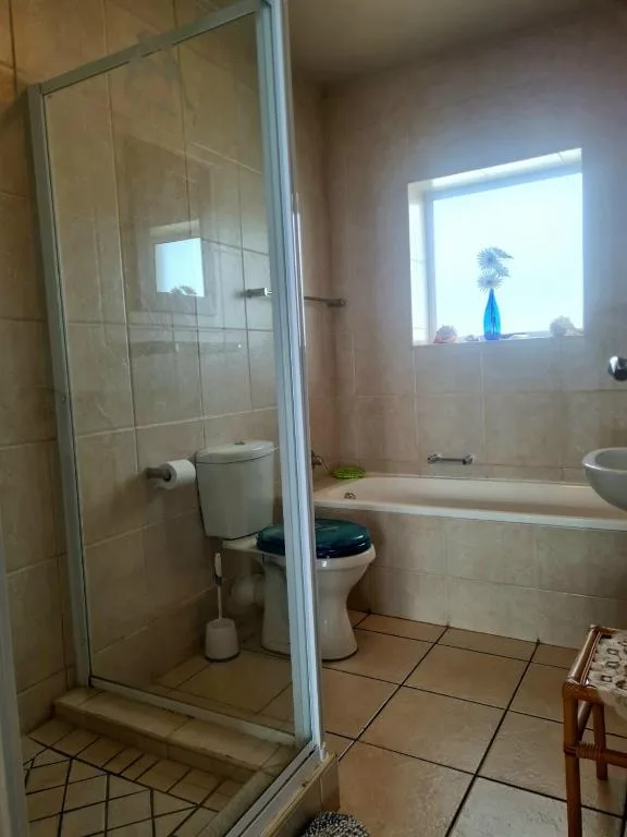 Spacious bathroom with glass shower enclosure and freestanding bath