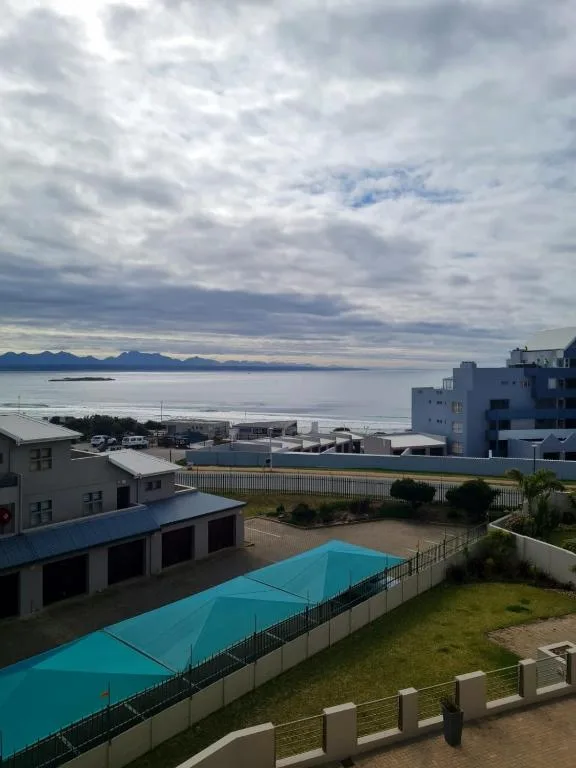 Scenic coastal view with mountains, sea, and property pool below