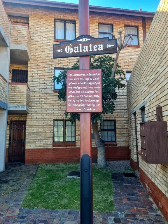 Brick building facade with Galathea signage and historic plaque