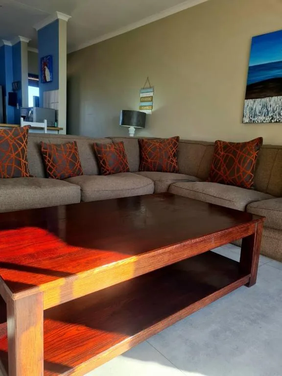 Spacious lounge with grey sectional sofa and wooden coffee table