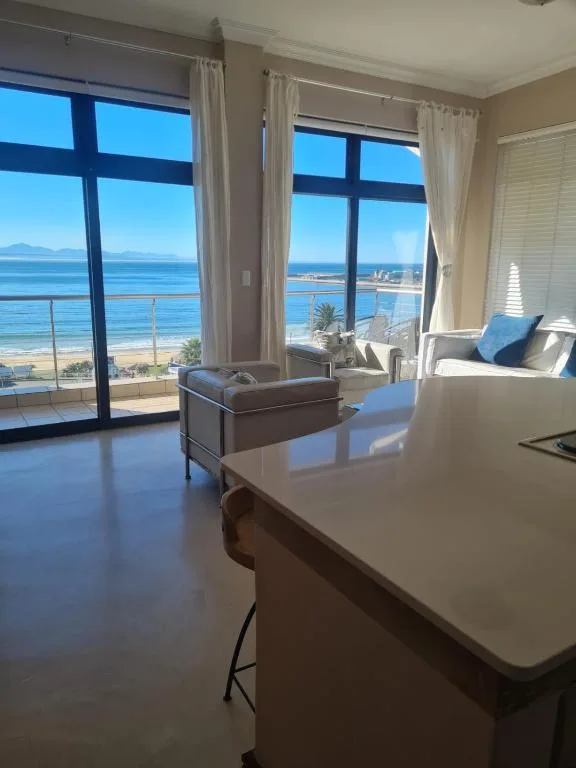 Modern lounge with ocean and beach views through large windows