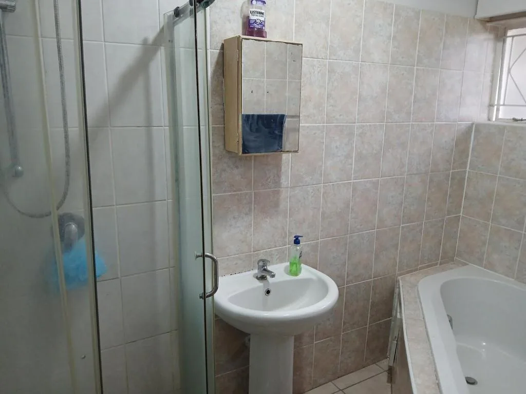 Bathroom with pedestal sink, shower enclosure, and bathtub