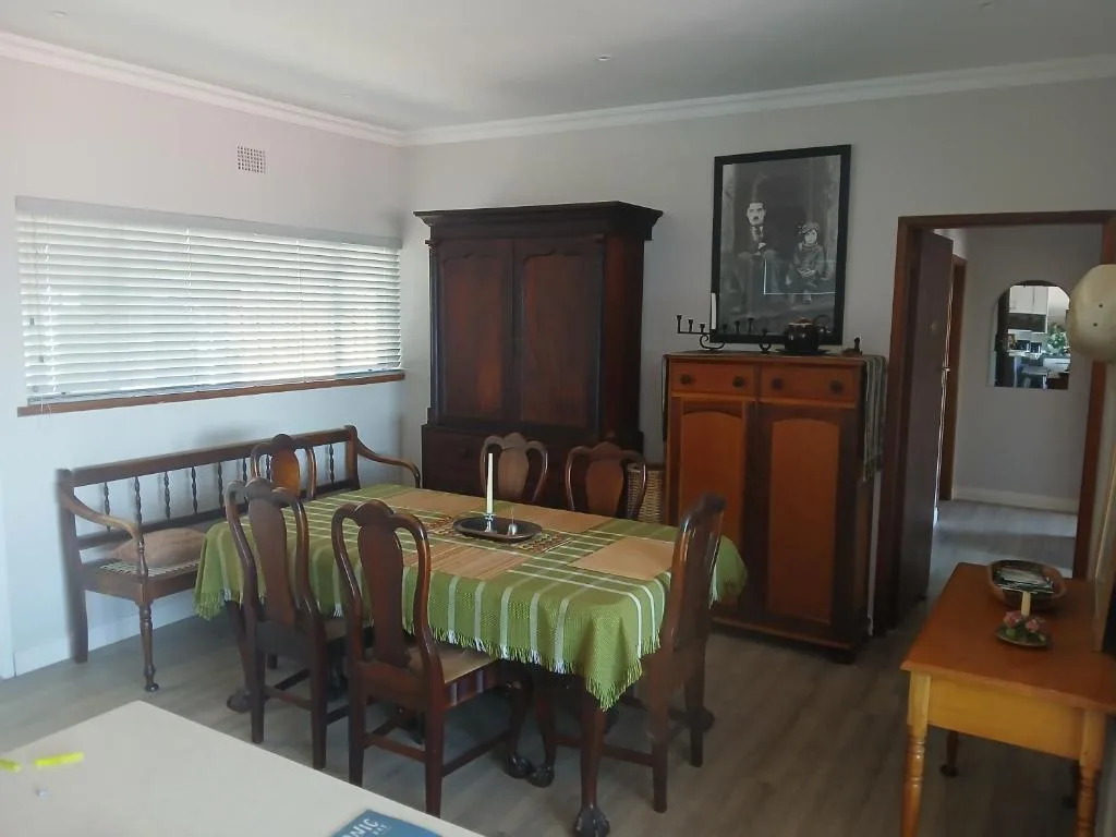 Dining room with wooden table, chairs, and traditional furniture decor