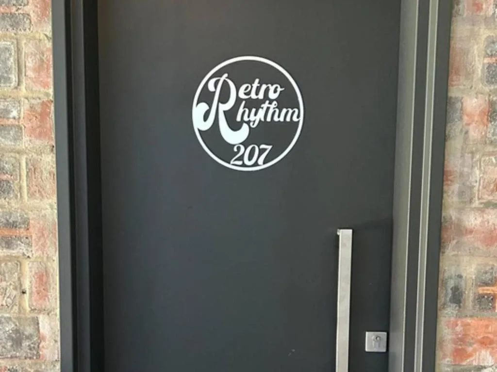 Retro Rhythm property entrance door with circular logo signage