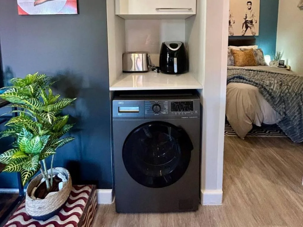 Modern laundry appliance with kettle and coffee maker in stylish alcove