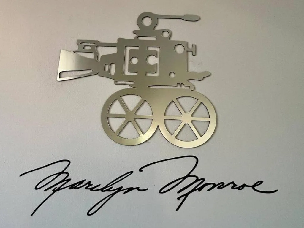 Metal movie camera decorative ornament with cursive text below