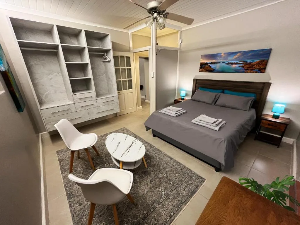 Spacious bedroom with queen bed, built-in wardrobe, and modern furnishings