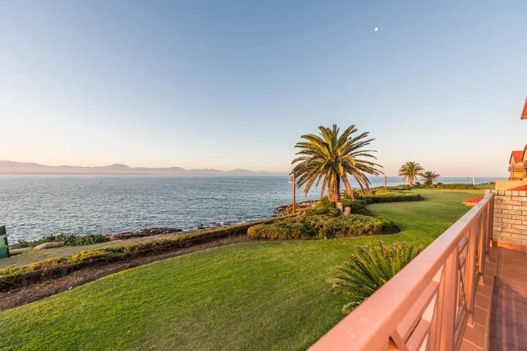 Lagoon and mountain vista from manicured lawn with palm trees