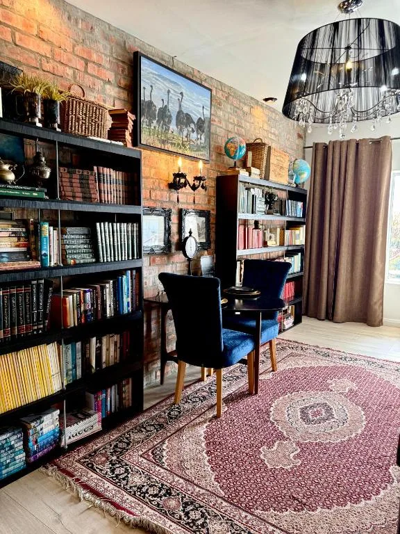 Cozy reading room with brick walls, bookshelves, and comfortable seating