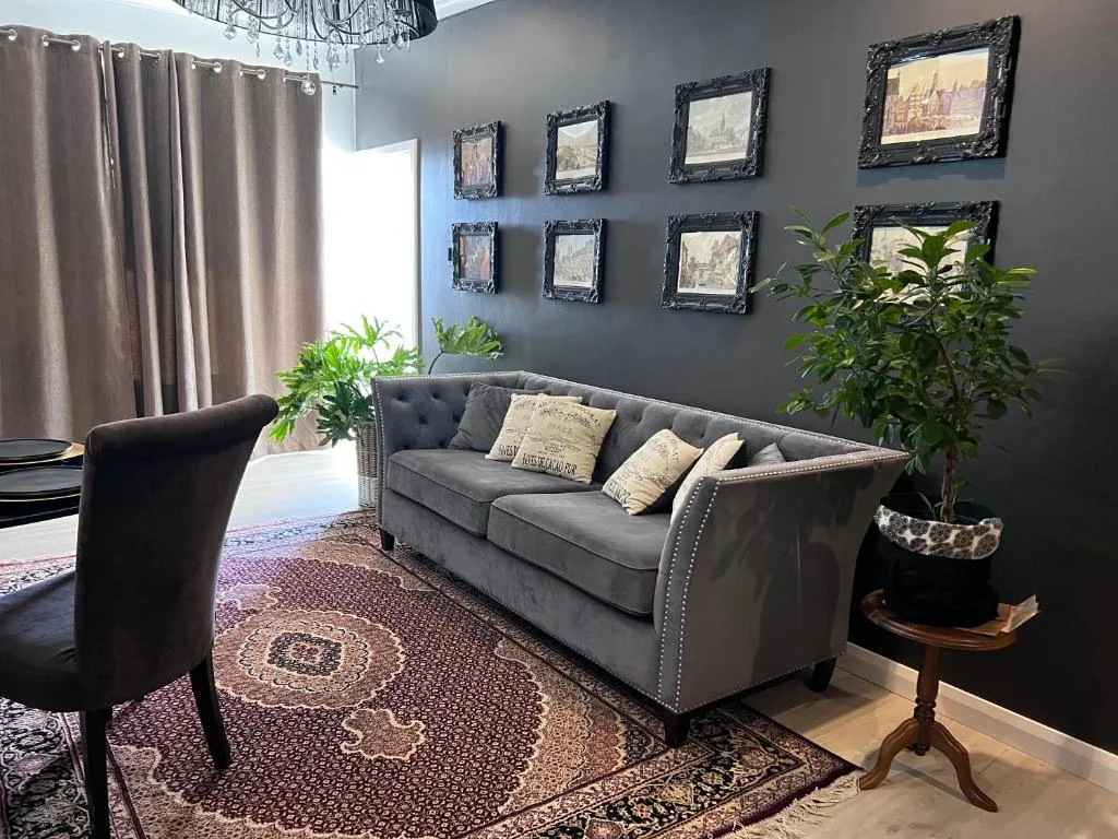 Elegant gray sofa with decorative pillows in contemporary living room