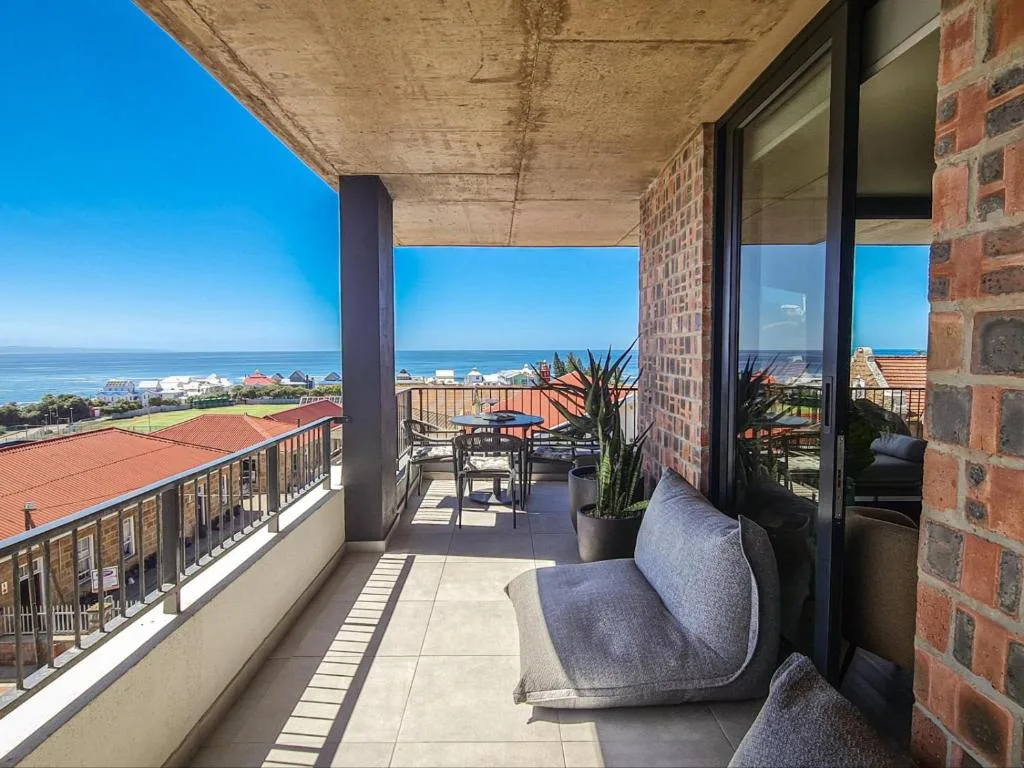 Spacious oceanview balcony with seating overlooking Mossel Bay coastline