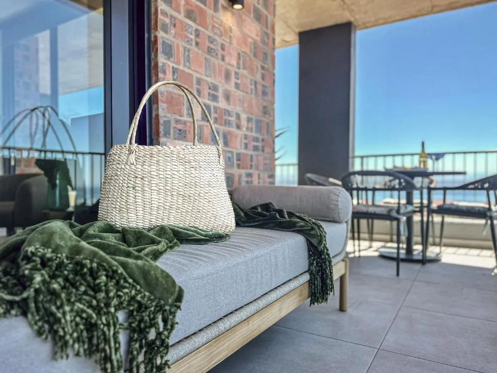 Stylish outdoor seating area with cushioned daybed and woven basket decor