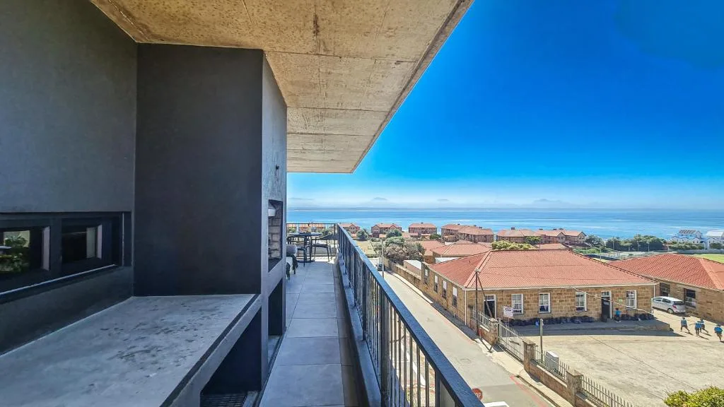 Panoramic coastal view from balcony overlooking town and ocean horizon