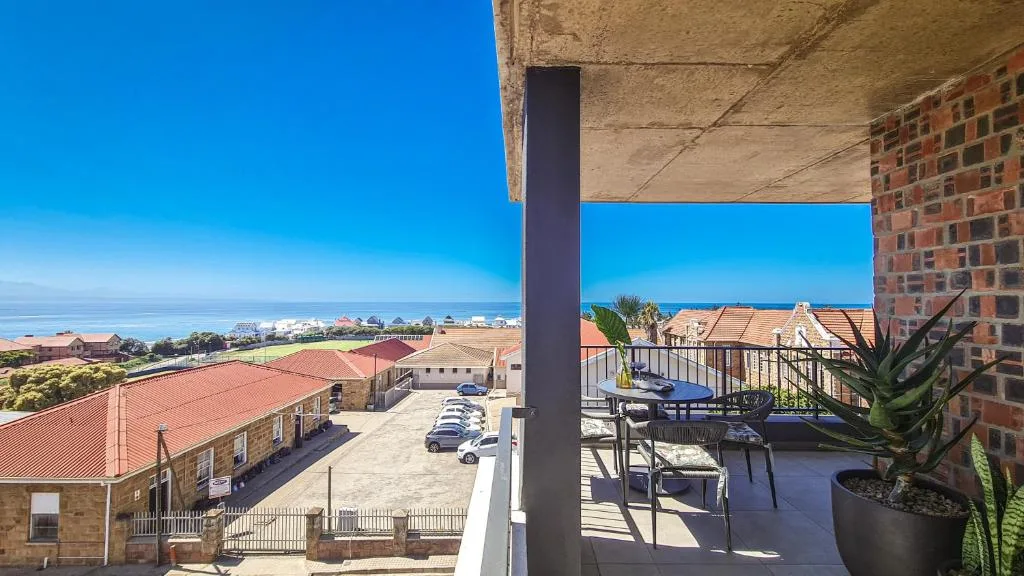 Expansive ocean and coastal town views from elevated deck area