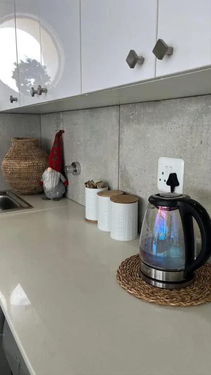Modern kitchen counter with electric kettle and decorative storage containers
