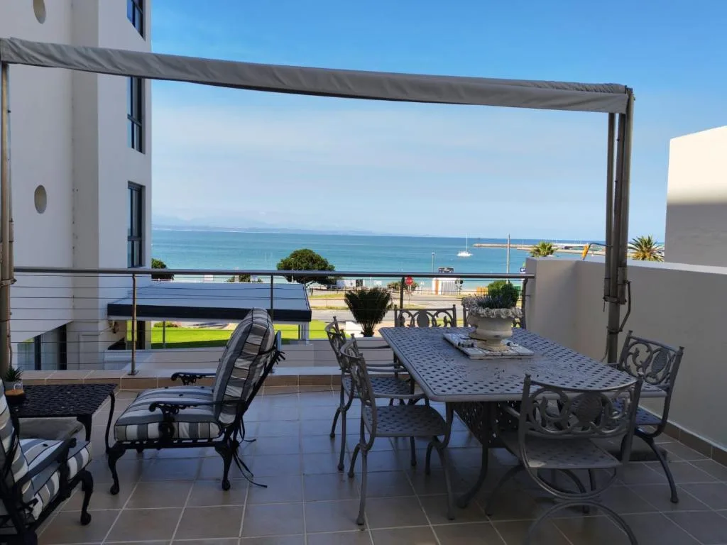 Oceanfront patio with dining table and sea views