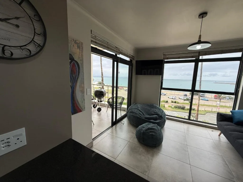 Spacious lounge with large windows overlooking the beach and ocean view