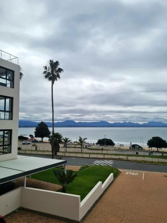 Scenic ocean and mountain vista from modern beachfront property deck