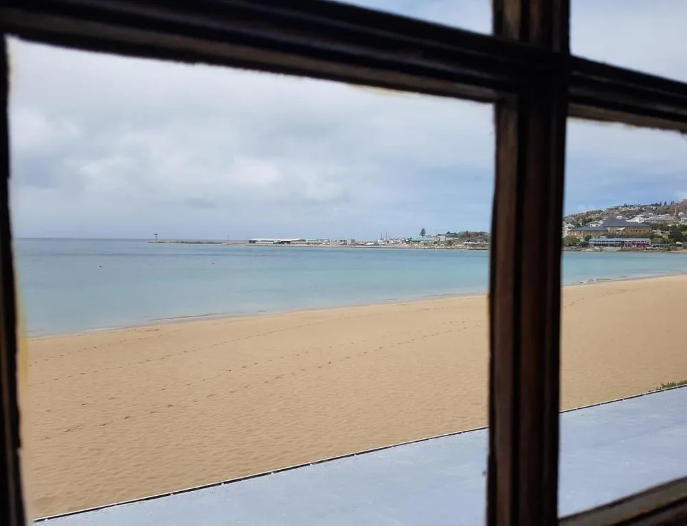 Beach and ocean view through large windows from property