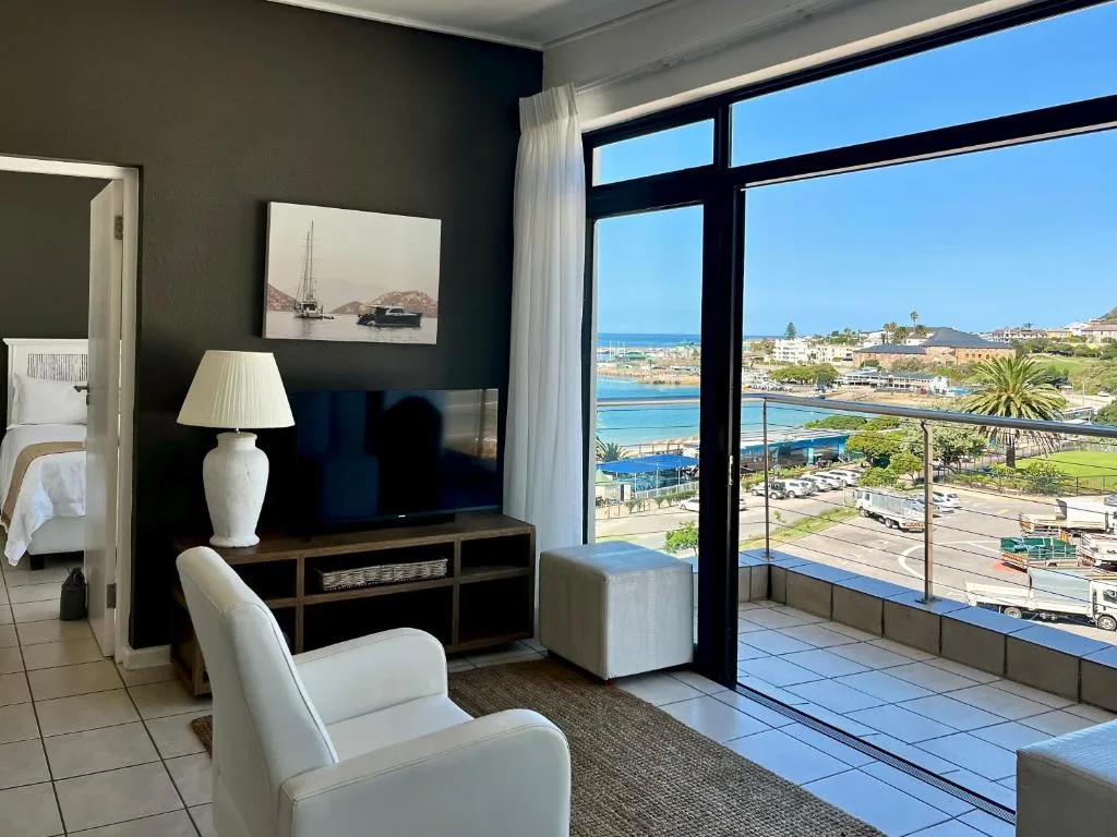 Modern lounge with ocean view overlooking Mossel Bay harbor and beach
