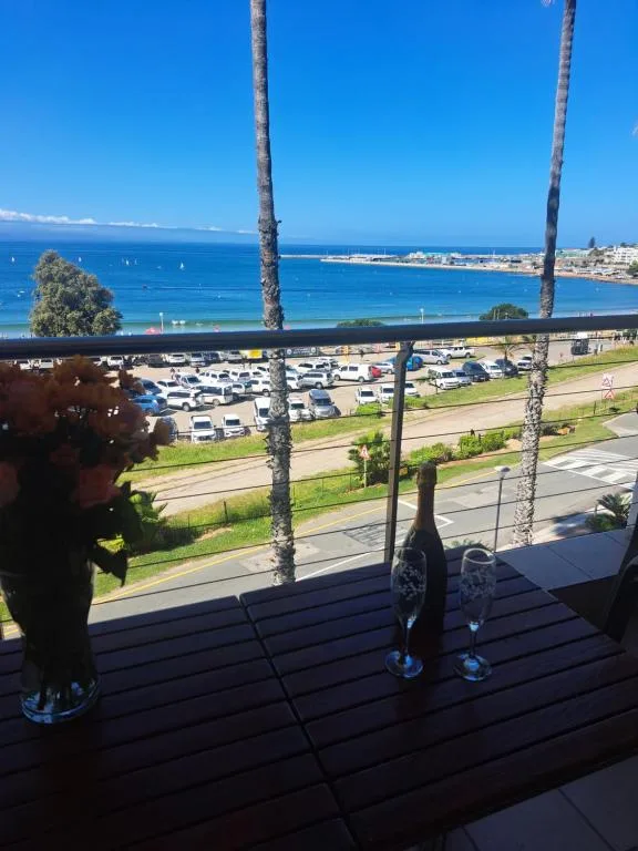 Coastal ocean view from property deck with beach and town in distance