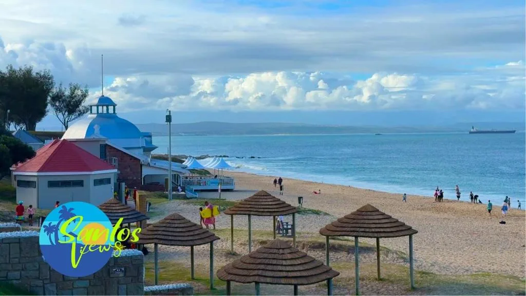 Scenic coastal beach view with mountains and ocean horizon visible
