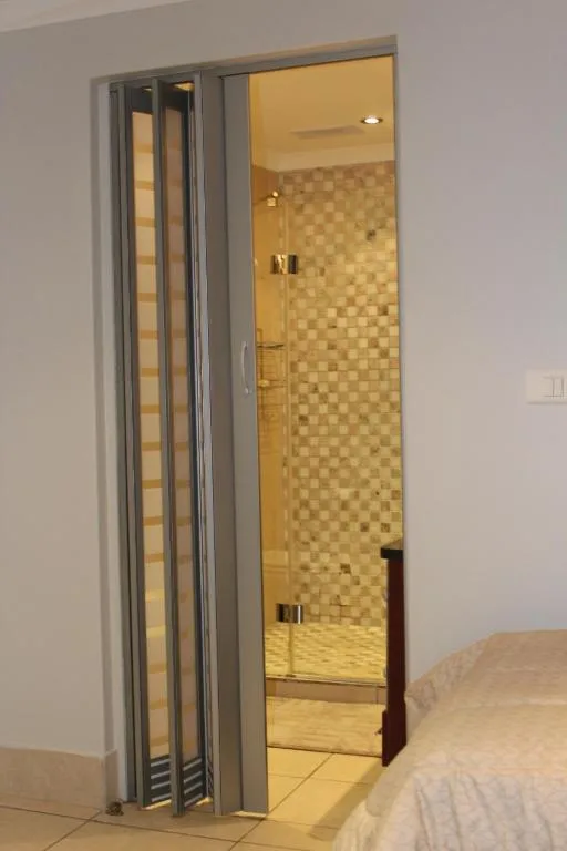 Modern ensuite bathroom with tiled shower and glass sliding doors