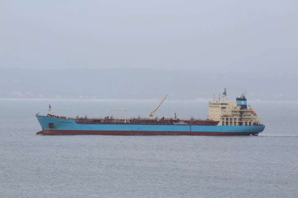 Large cargo ship anchored offshore in Mossel Bay waters
