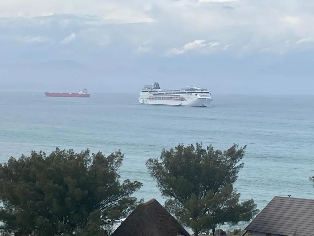 Turquoise ocean with cruise ships anchored offshore from property