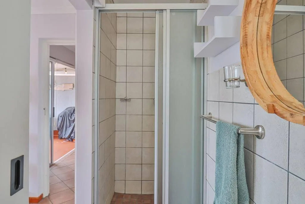 Modern bathroom with walk-in shower enclosure and teal towel