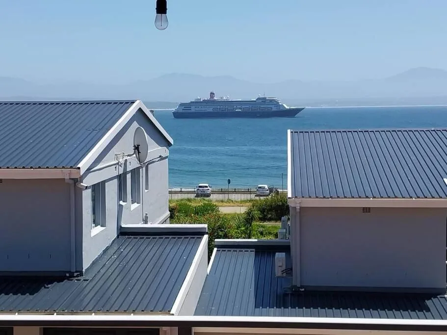 Scenic ocean view with cruise ship and mountains from property rooftop