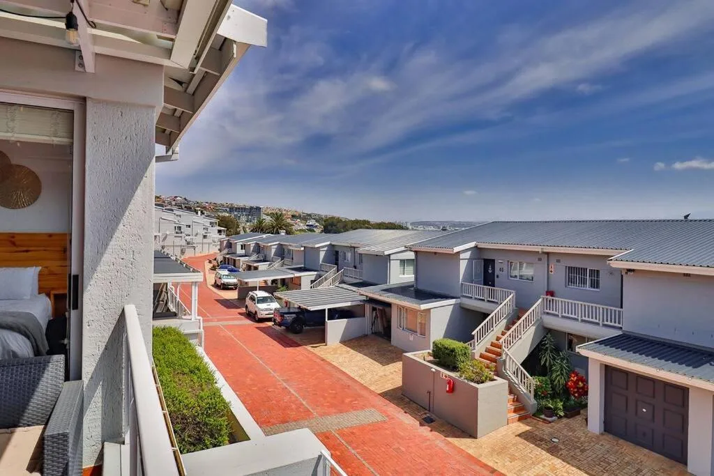 Coastal town vista with lagoon and distant bridge from property balcony