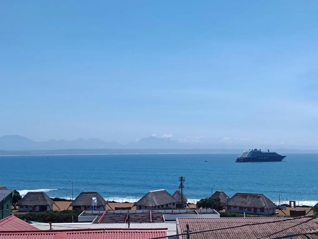Cruise ship anchored in blue ocean waters off Mossel Bay coastline