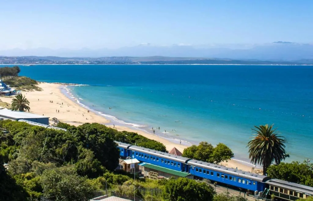 Turquoise ocean, sandy beach, and coastal town from elevated viewpoint