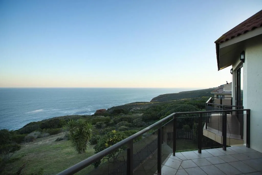 Expansive ocean and coastline view from property deck at sunset