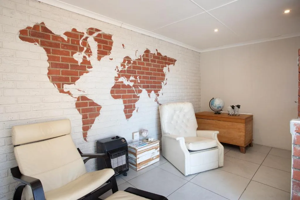 Modern lounge with world map wall art and comfortable seating