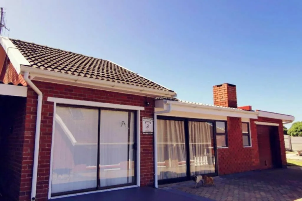 Red brick cottage with tiled roof and glass sliding doors