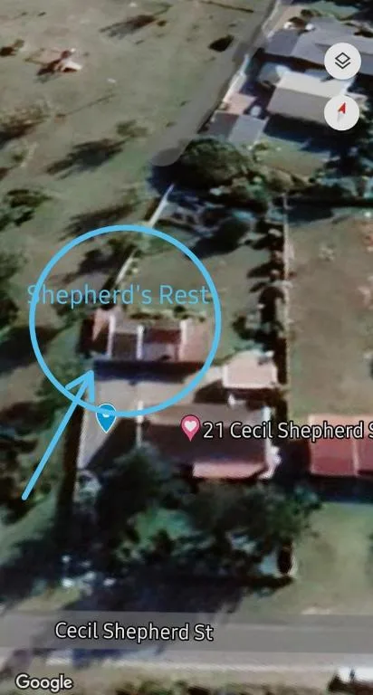 Aerial view of Shepherd's Rest property with surrounding gardens and driveway