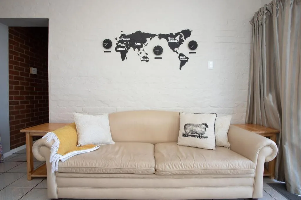 Cream upholstered sofa with decorative pillows in living room space