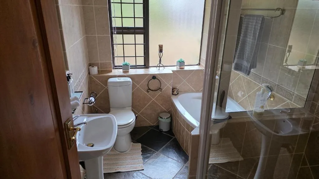 Spacious bathroom with toilet, bidet, bathtub and shower enclosure