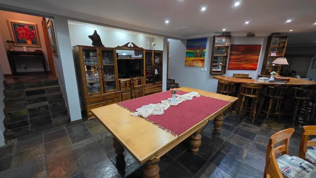 Game room with pool table, entertainment center, and bar seating area
