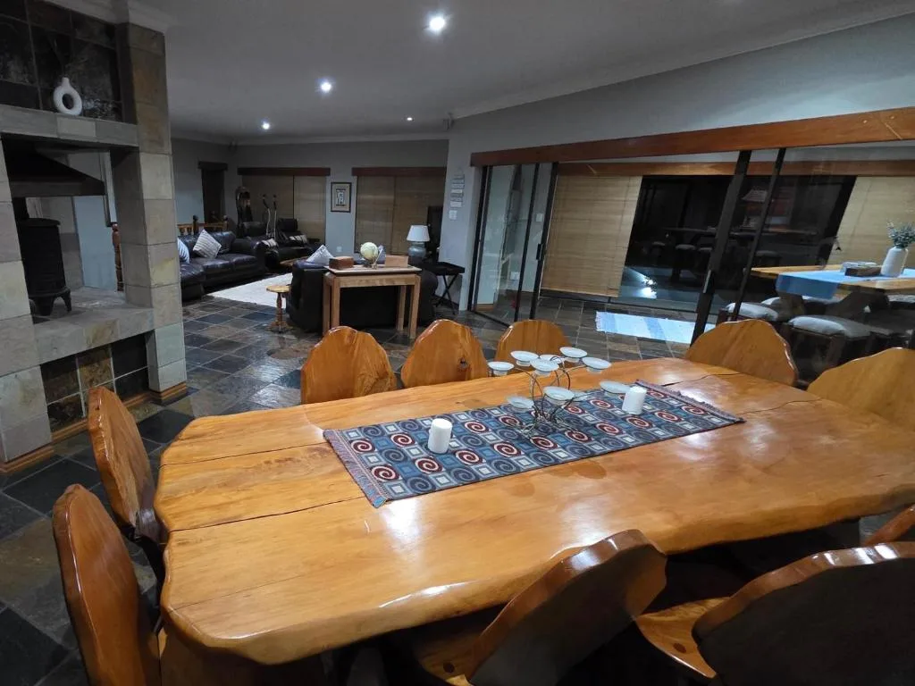 Large wooden dining table with six chairs in open-plan living space