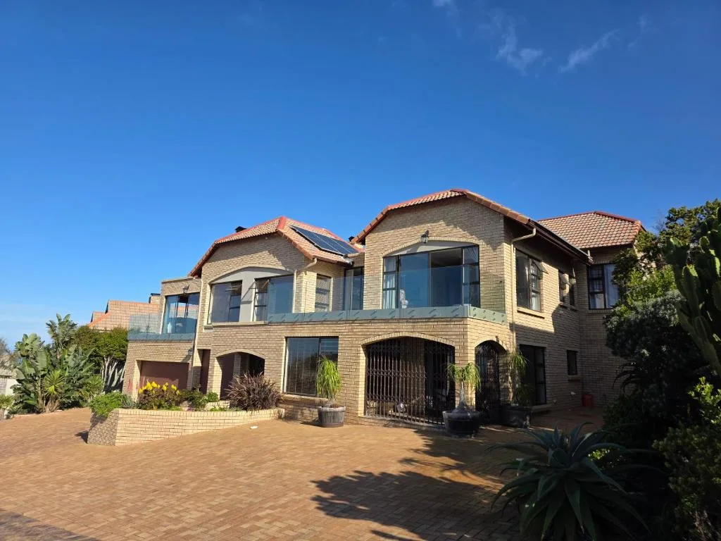 Brick home with terracotta roof and curved archways in Mossel Bay