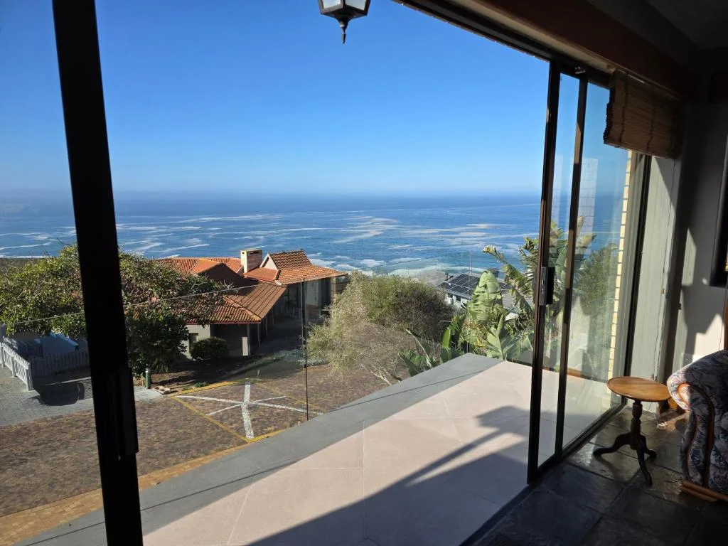 Expansive coastal view of Mossel Bay lagoon from modern deck area