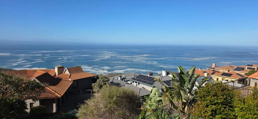 Expansive ocean and lagoon vista from hilltop property with coastal landscape